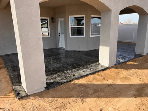Completed custom backyard patio with finished concrete work