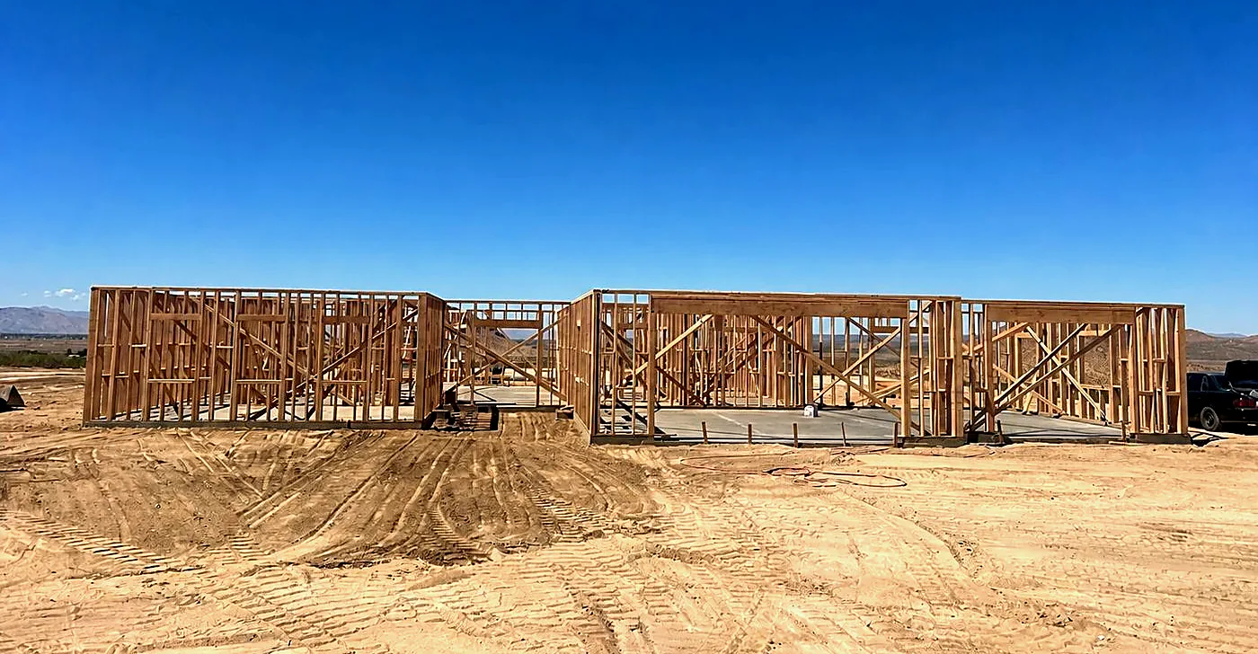 Wood framing standing on the finished slab at the same desert site