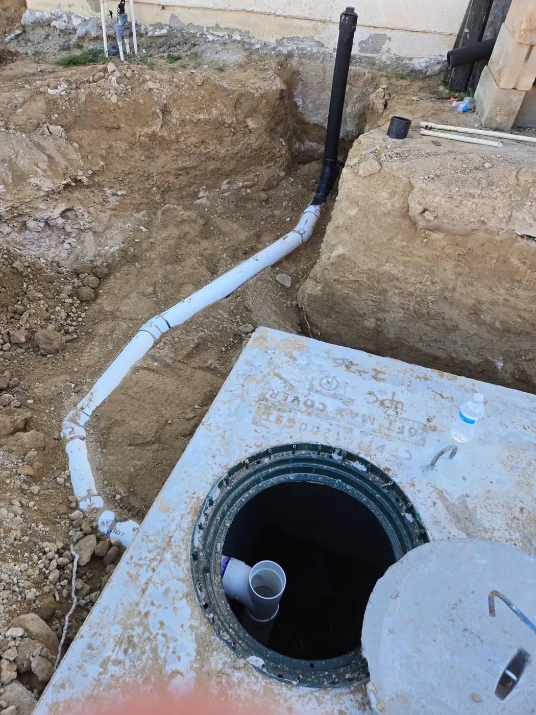 Septic system installation in progress at a construction site