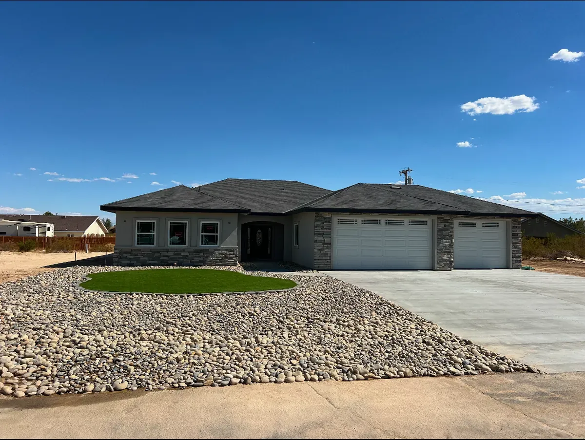 Completed single residential home with a broad concrete driveway